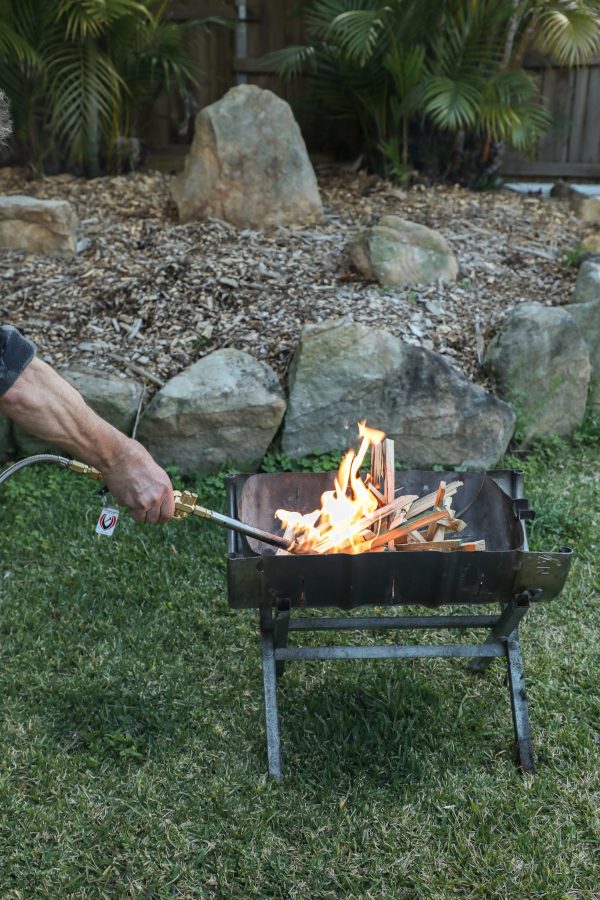 fire starting tool lighting firewood in a firepit